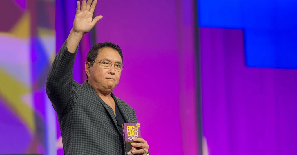 Robert Kiyosaki with his book Rich Dad Poor Dad