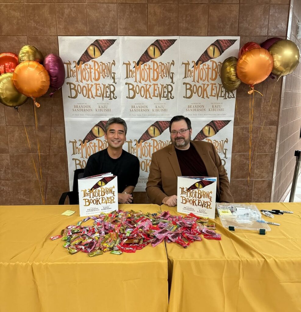 Brandon Sanderson with his books